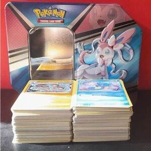 Sylveon Pokemon Tin with 400 Pokemon TCG cards inside eeveelutions